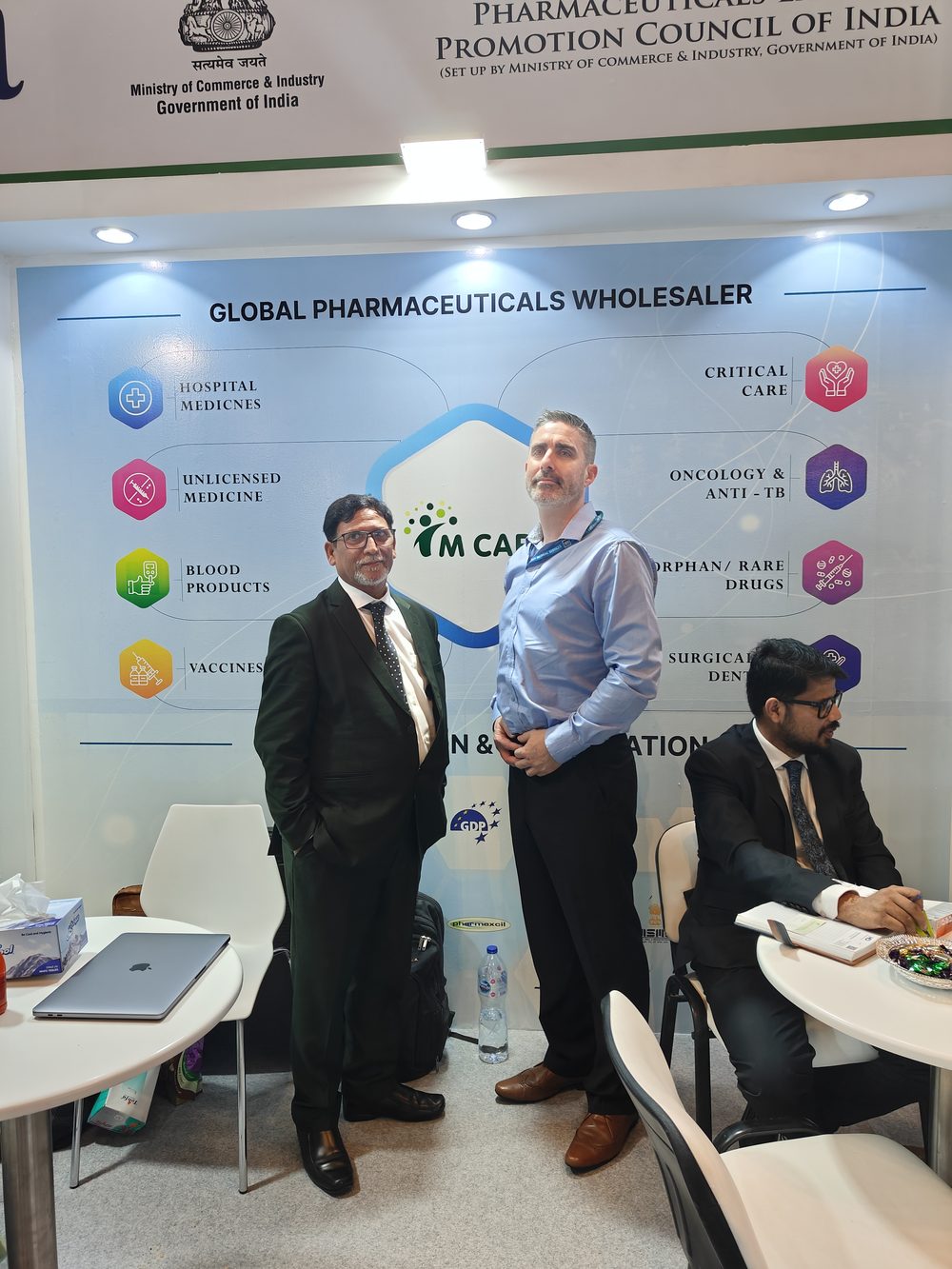 M Care Arab Health 2024 booth — category tiles wall with hospital medicines, critical care, oncology.