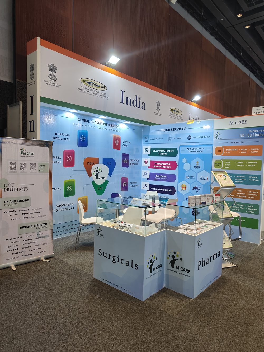 M Care Arab Health 2025 booth — category tiles, team in conversation with buyer.